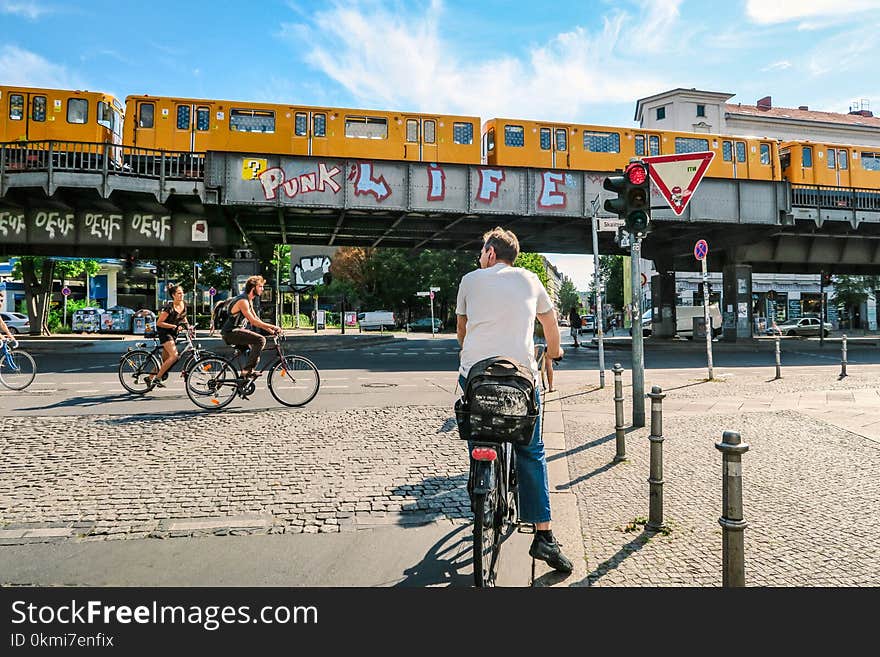 Man Stop As the Two Cyclist Passes by Near Train