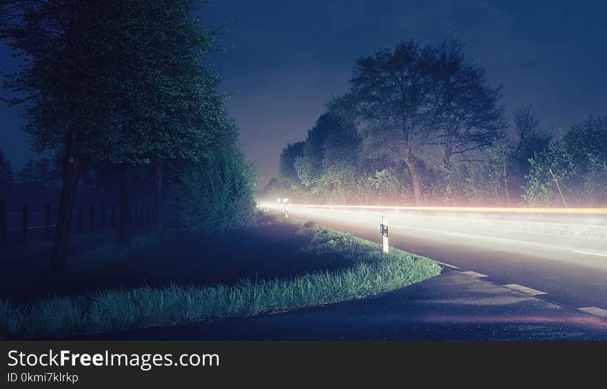 Time Lapse Photograph of Gray Road Near Trees