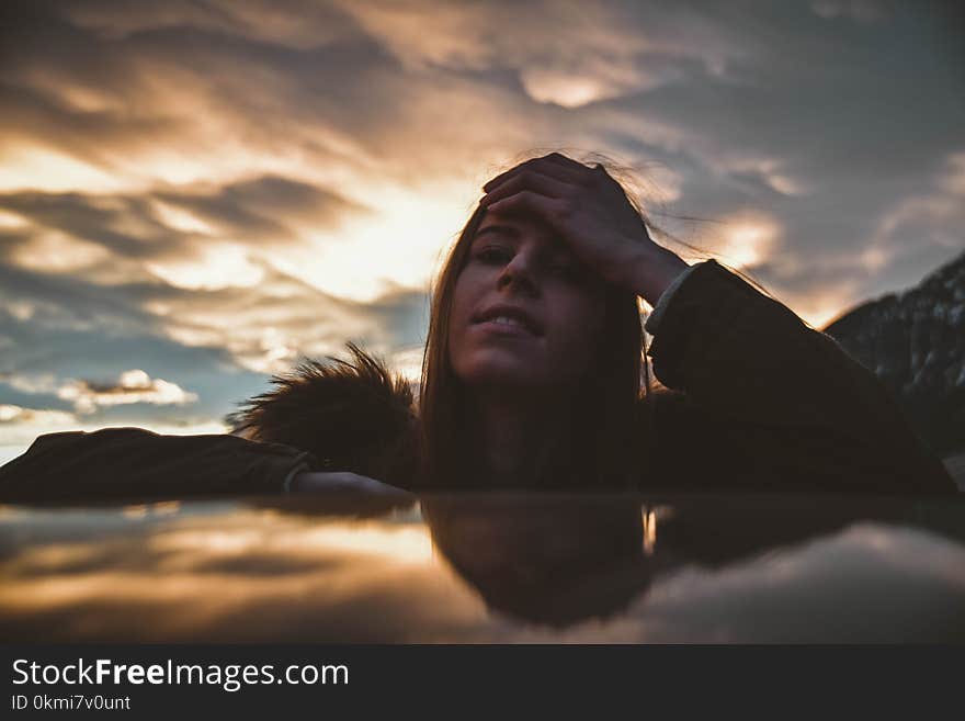 Woman Wearing Brown and Green Parka at Golden Hour