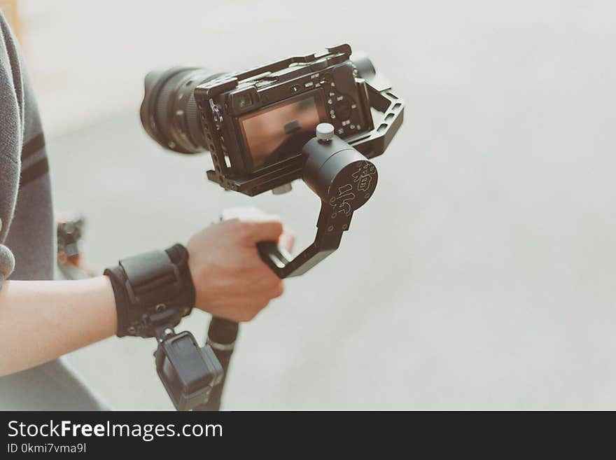 Person Holding Black Dslr Camera