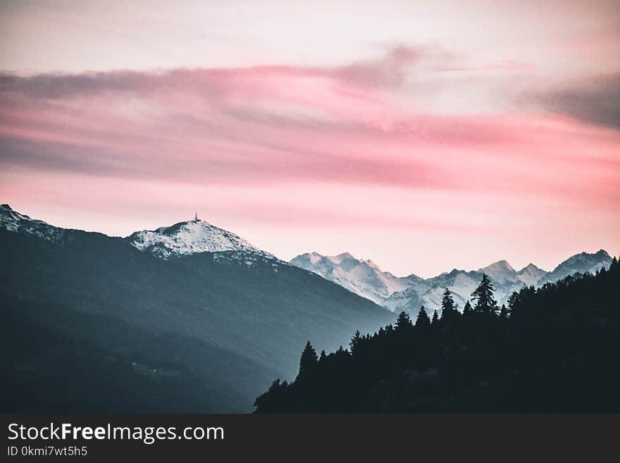 Snow Capped Mountains Under the Cloudy Skies