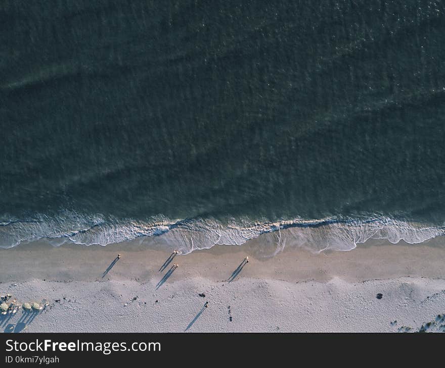 Gray Sand Near Body of Water