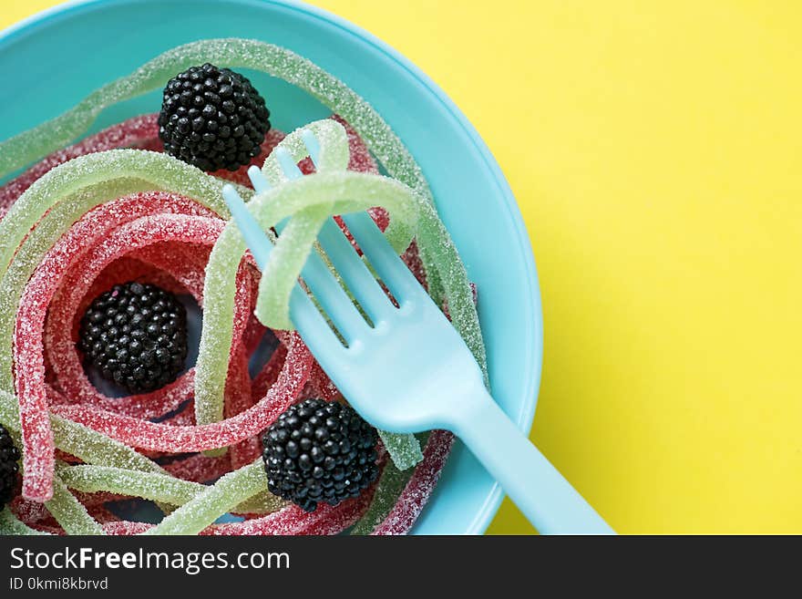 Assorted-colored Jellies on Teal Plastic Bowl