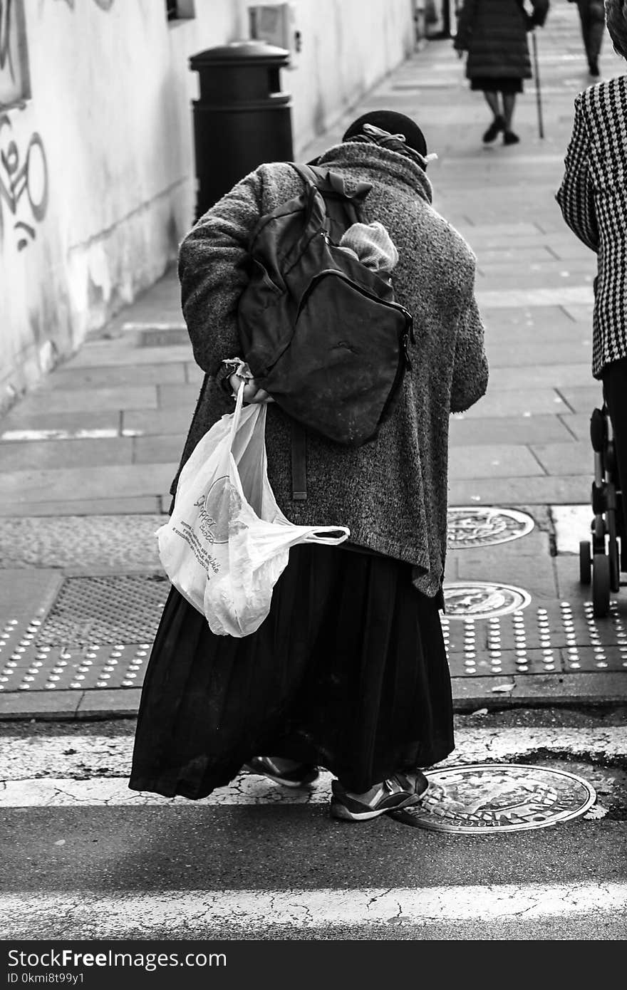 Man Holding Plastic Bag With Coat