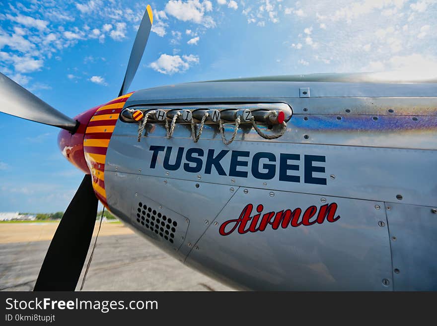 Gray Tuskegee Airmen Airplane Under Blue and White Cloudy Skies at Daytime