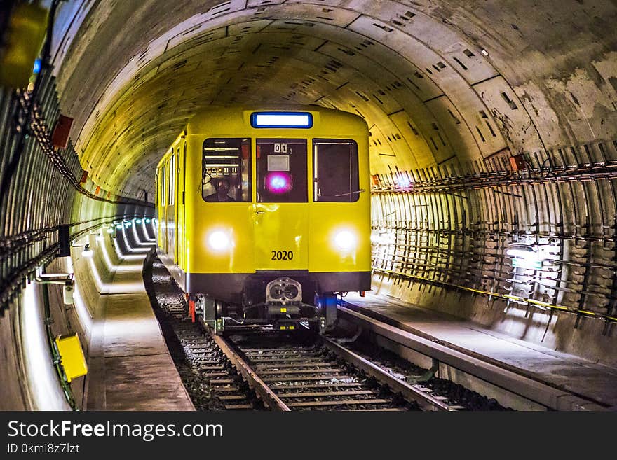 Yellow and Black Train Under Tunnel