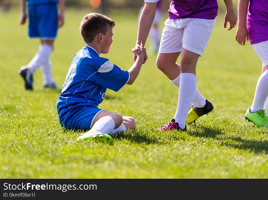 Young children players football match on soccer field