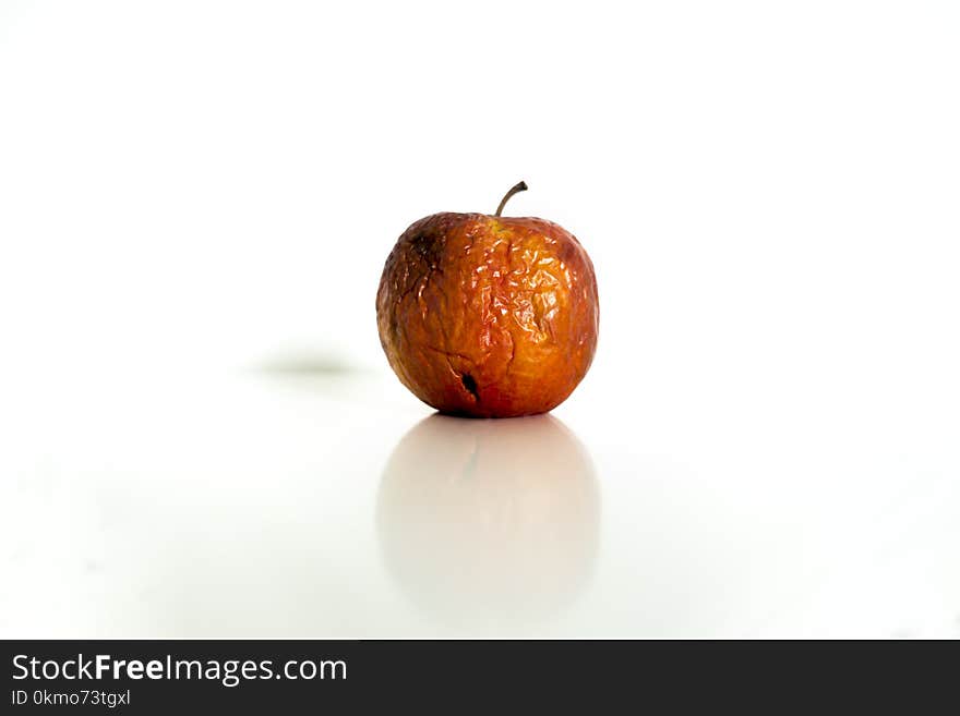 Old red-apple with wounds on white background. Old red-apple with wounds on white background