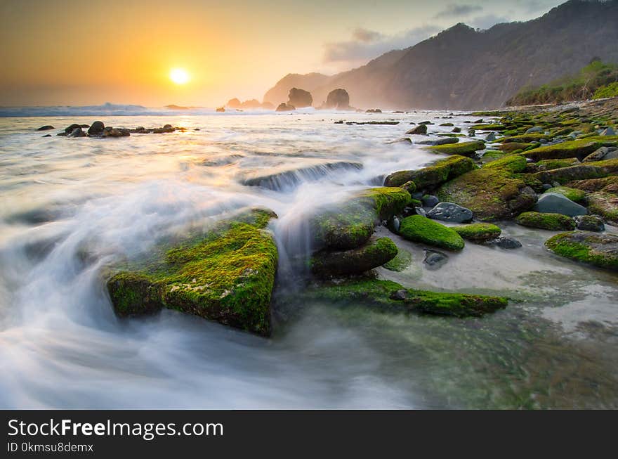 Amazing landscape sunset at papuma beach, indonesia