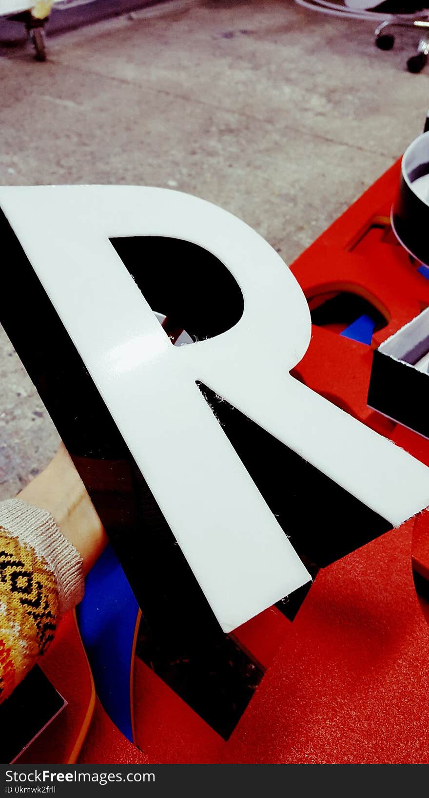 Person Holding White R Marquee