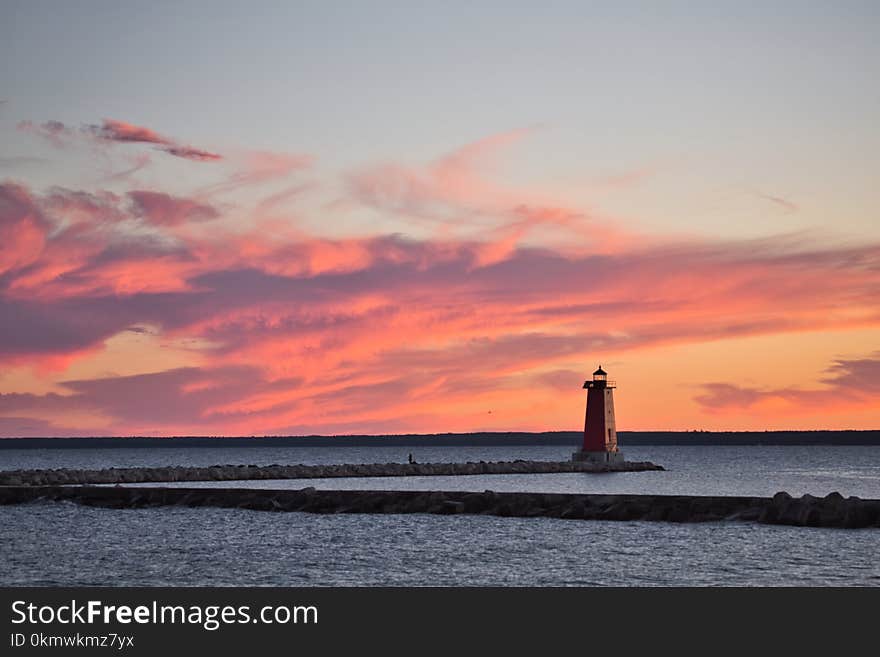 Lighthouse Surrounded by Body of Water