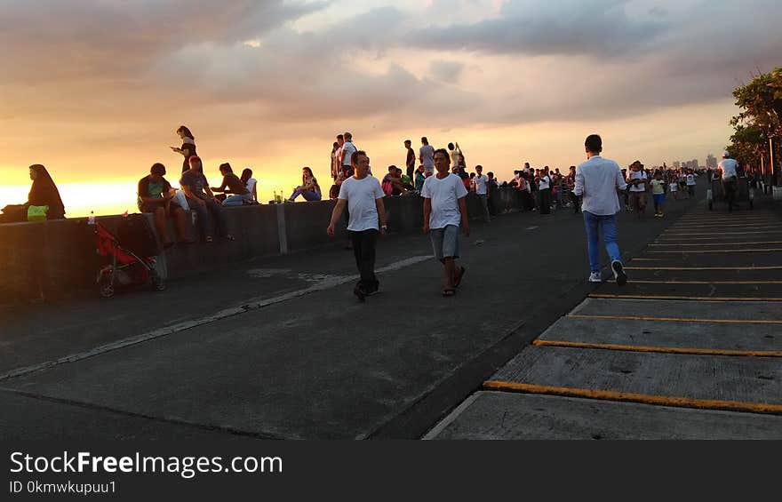 Group of People Walking on Pavement