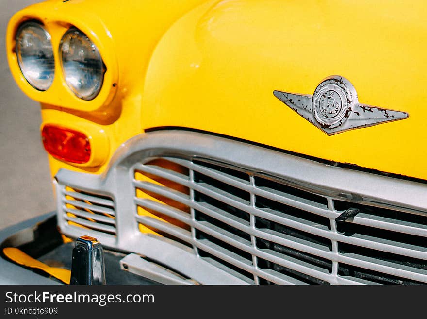 Closeup Photograph of Yellow Car Grille