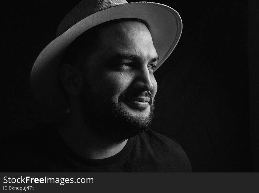 Grayscale Photo of Man Wearing Fedora Hat