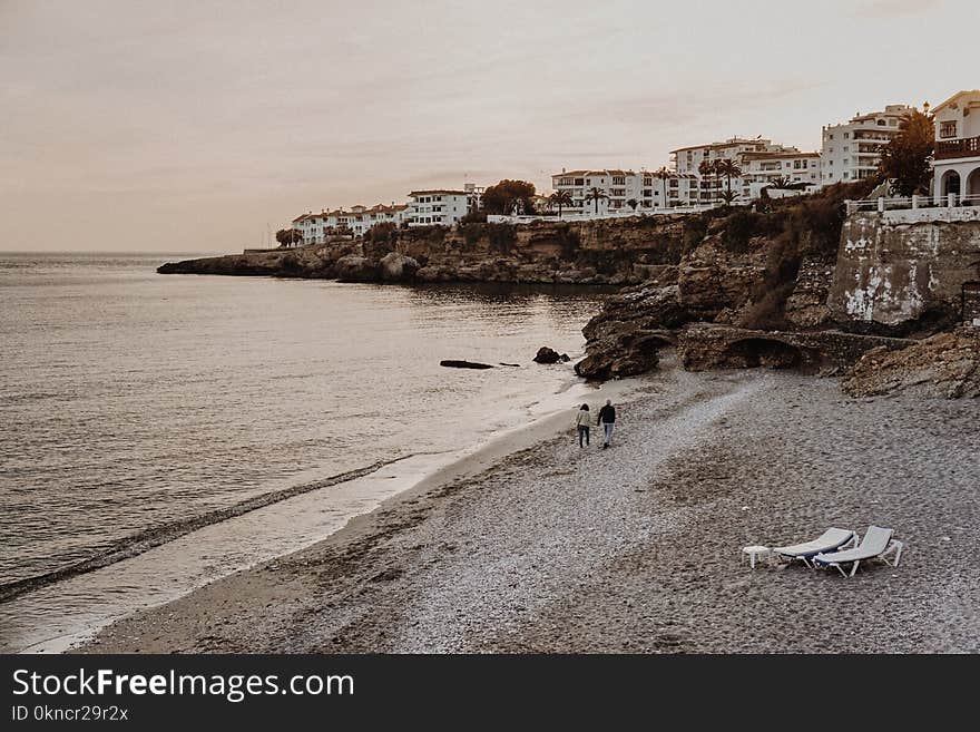 Two Person Walking on Seashore