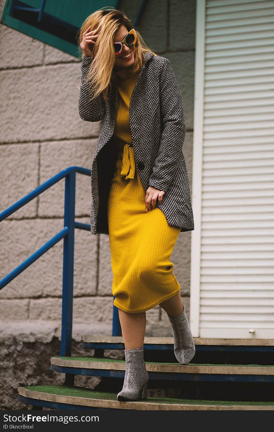 Woman Smiling While Walking on Stairs