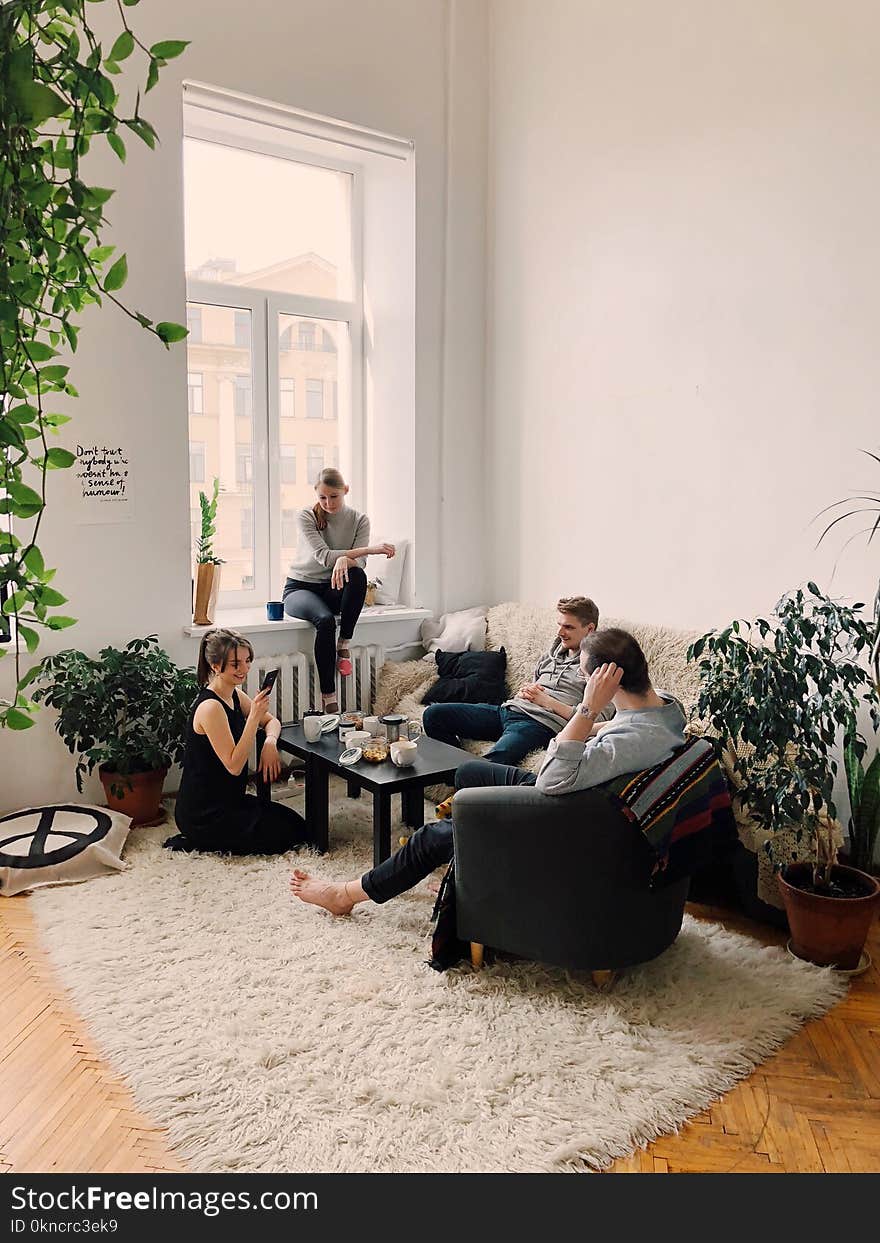 People Gathered Inside House Sitting on Sofa