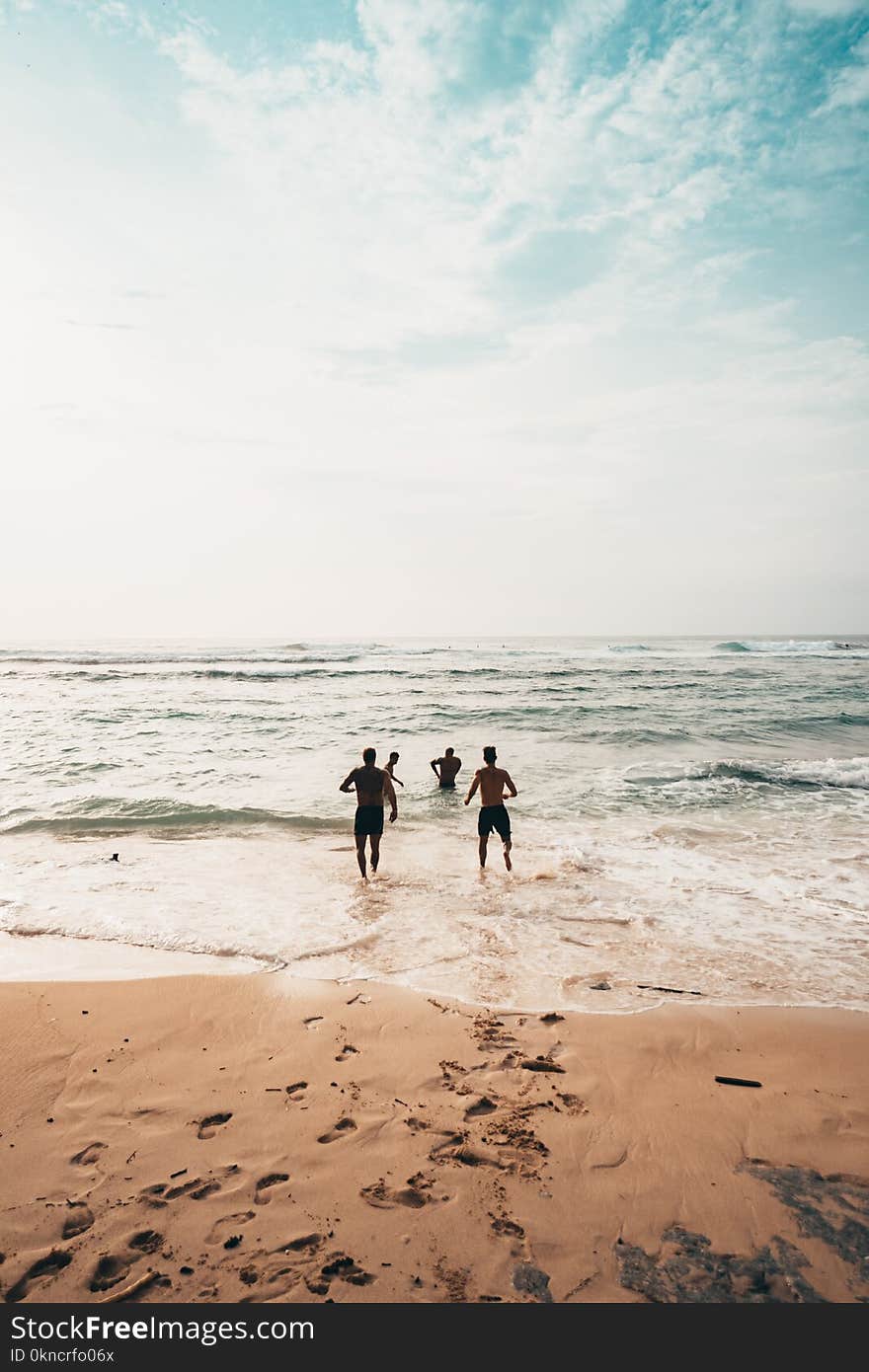 People Running Near Seashore at Daytime Photo