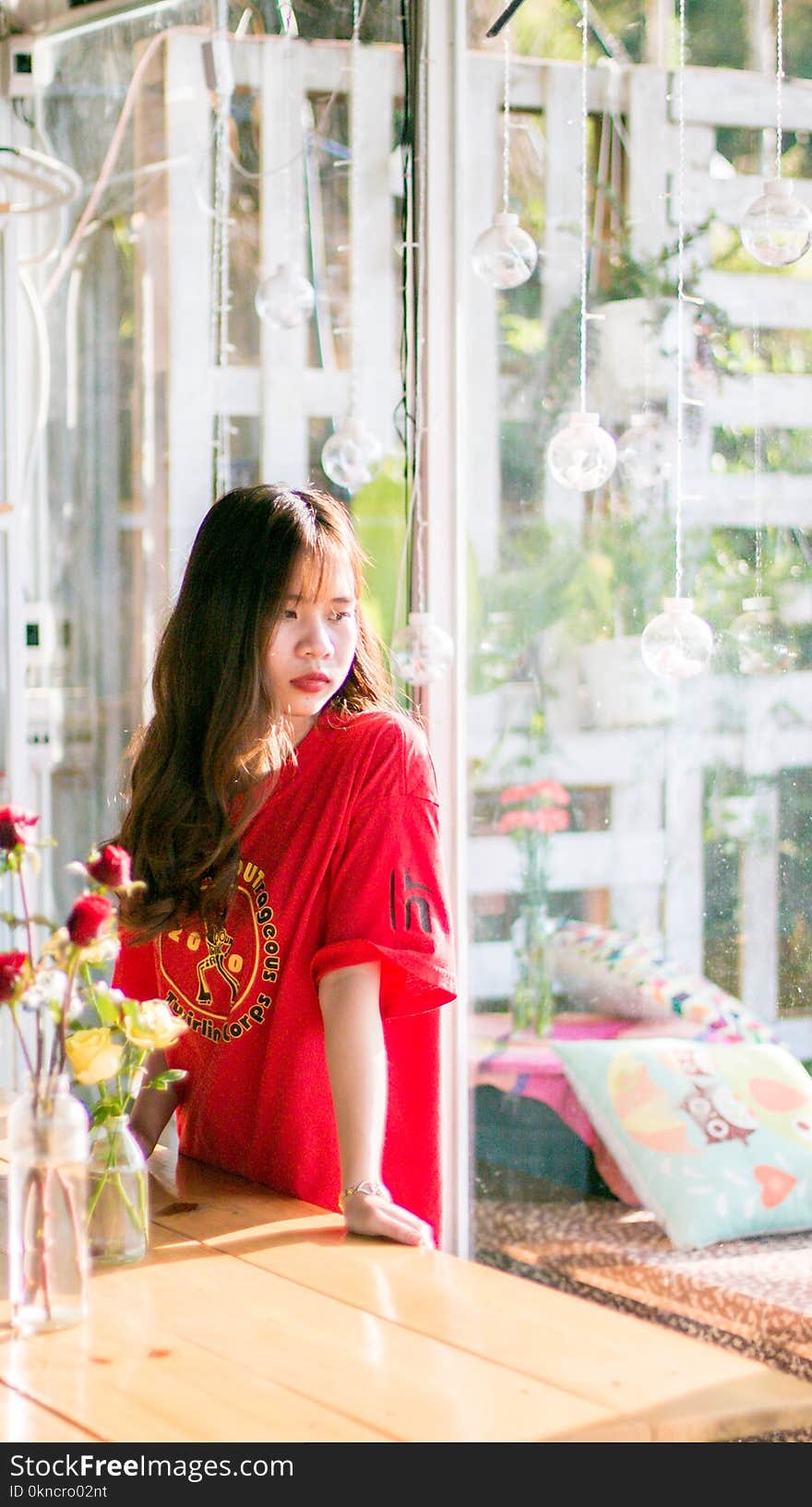 Woman Wearing Red Shirt Standing Near Table