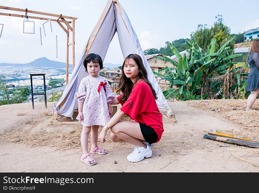 Woman Beside Gift in Front of Tent