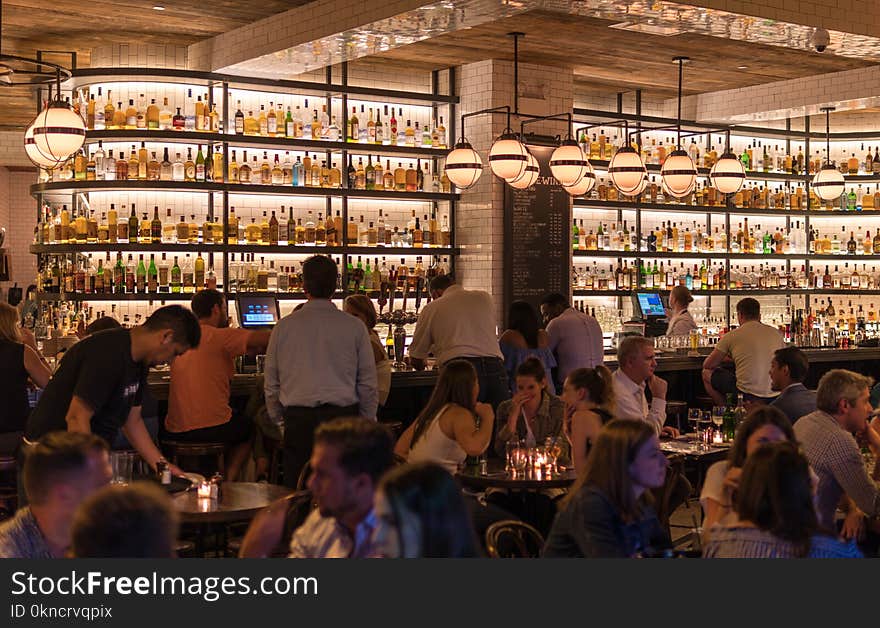 Group of People Gathering Inside Bar