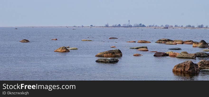 Brown Rocks on Body of Water