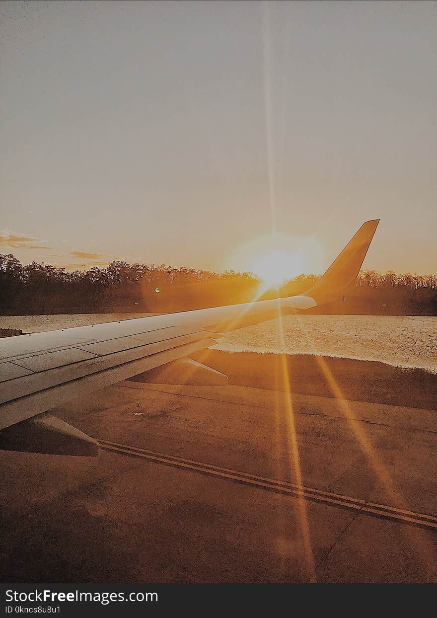 Photo of Airplane Wing during Golden Hour