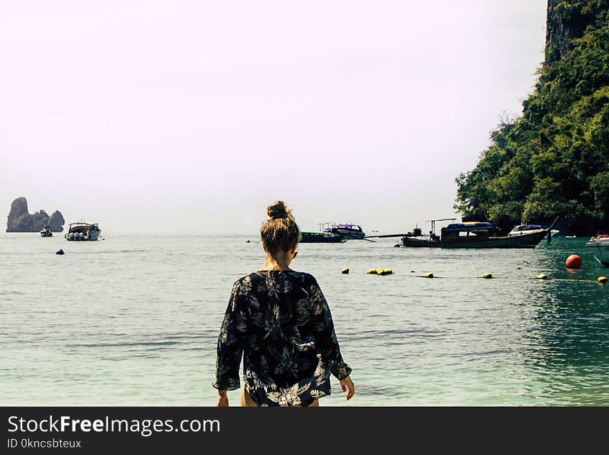 Woman Wearing Black and White Floral Top in the Beach