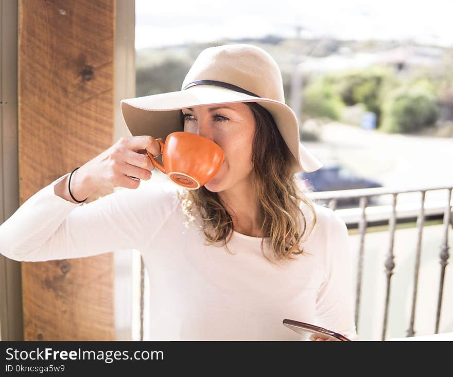 Woman Wearing Hat Holding Mug