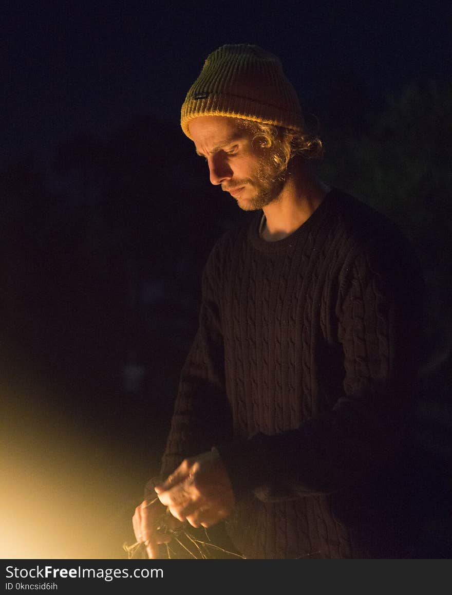 Man Wearing Black Sweater and Holding Rope