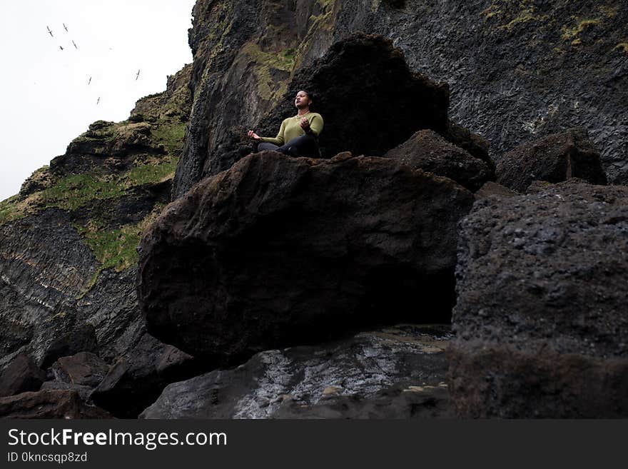 Person Doing Yoga on Rocky Mountain