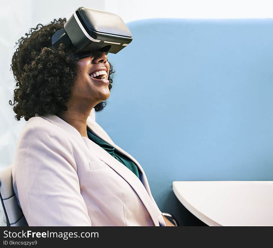 Woman Wearing White Robe and Black Virtual Reality Headset