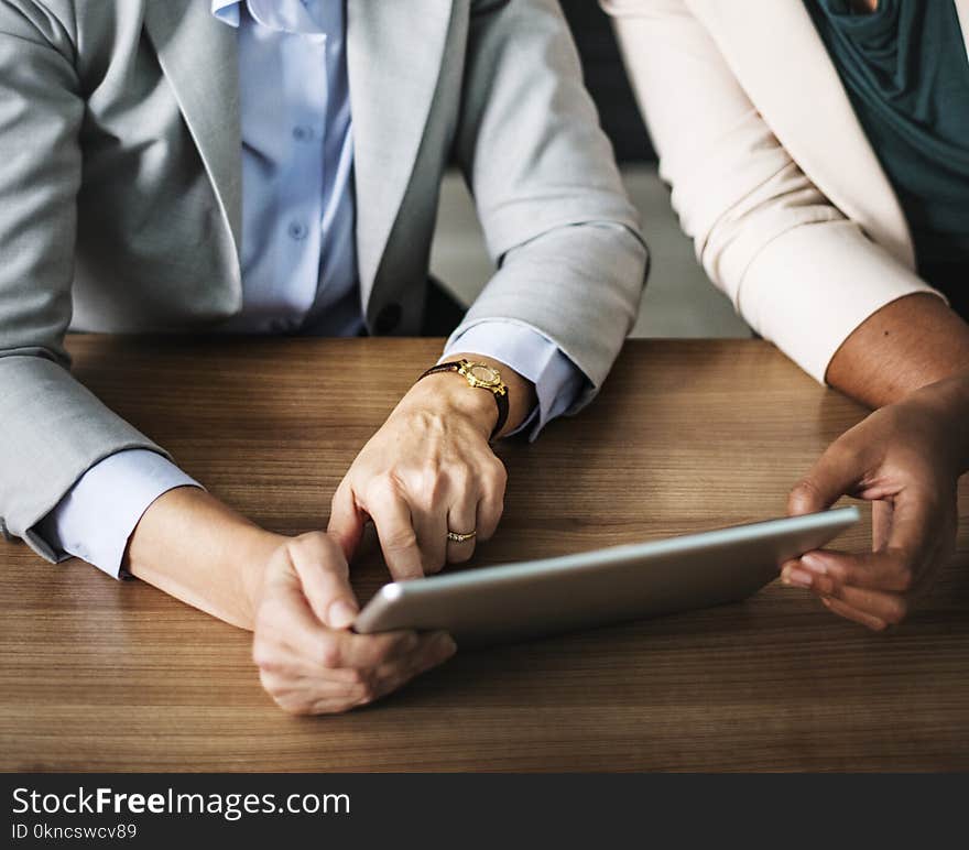 Two Person Using Gray Tablet