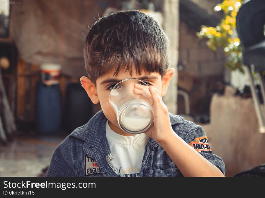 Boy Holding Clear Drinking Glass