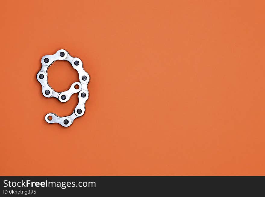 Gray Bicycle Chain on Orange Surface