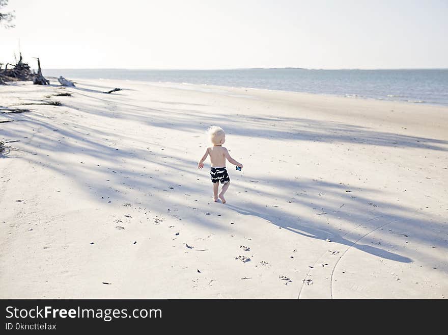 Boy Walking on Beach