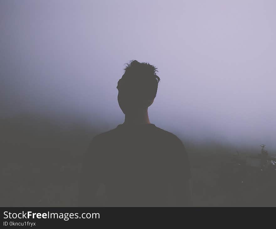 Man Standing Facing White Fogs