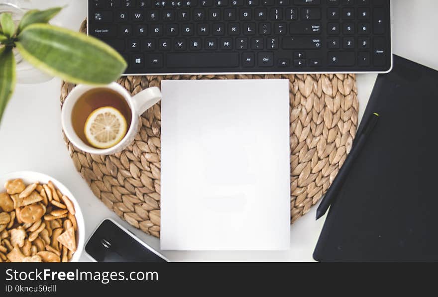 White Printing Paper Near Black Computer Keyboard