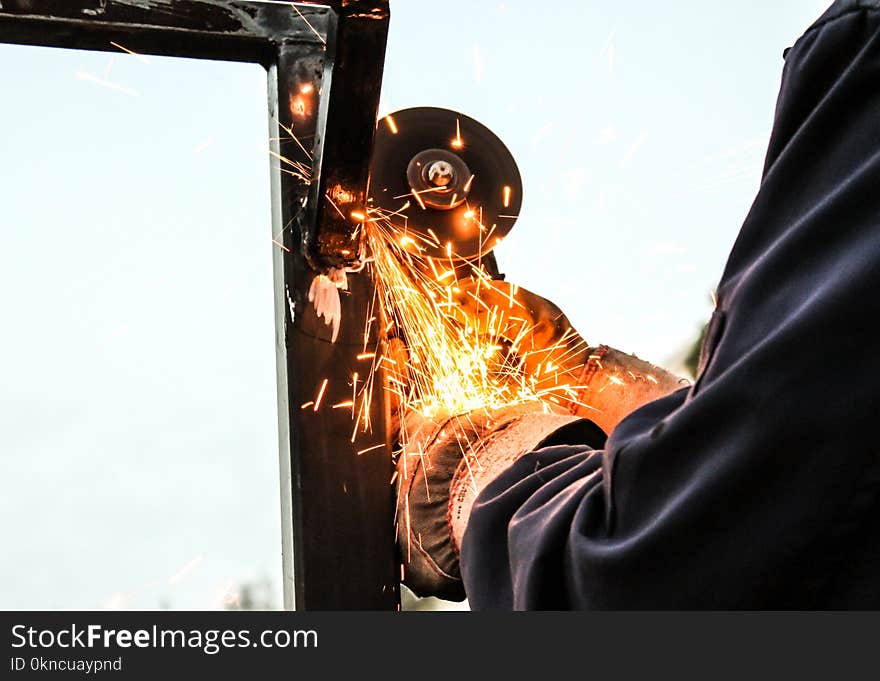 Person Holding Angle Grinder