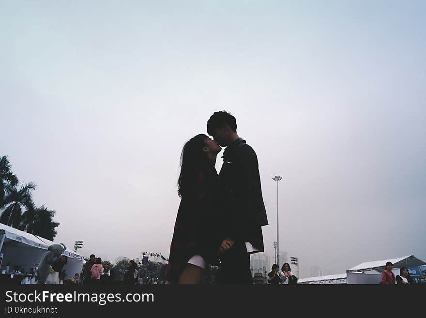 Couple Kissing Together Standing Near People