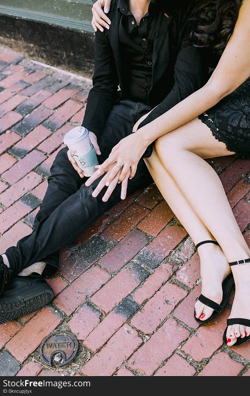 Man and Woman Sitting on Tiled Floor