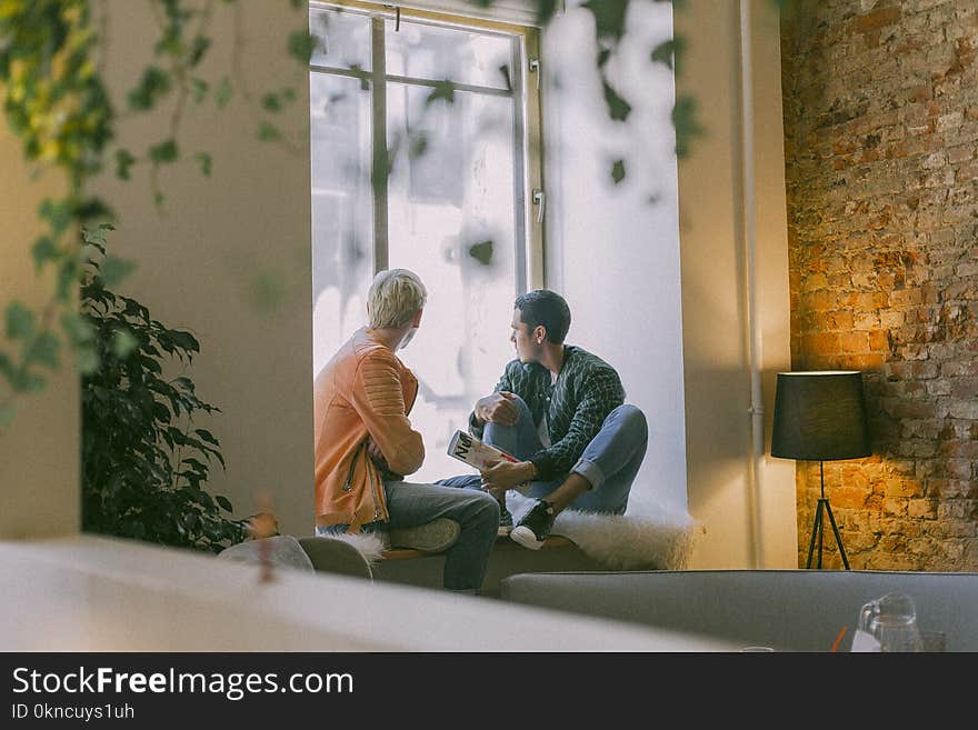 Two Men Near the Window Talking