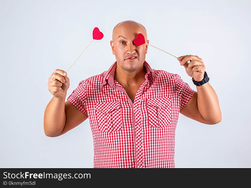 Cheerful Man In A Shirt On A White Background Holding Hearts, A Postcard For Valentine`s Day