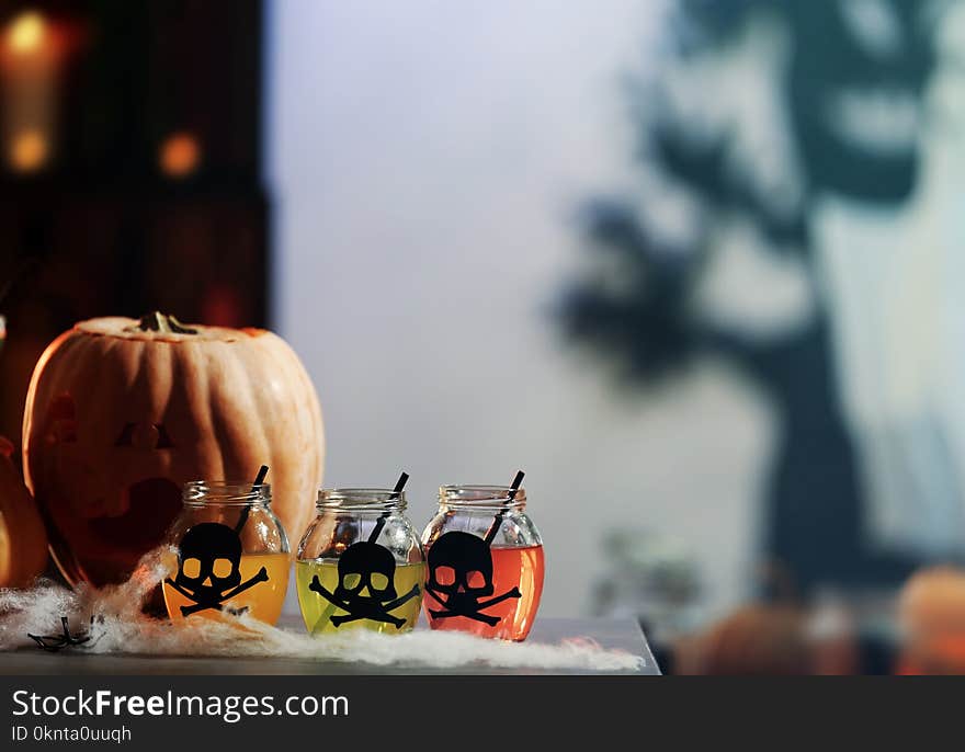 Colorful cocktails and decor for Halloween party, on blurred background