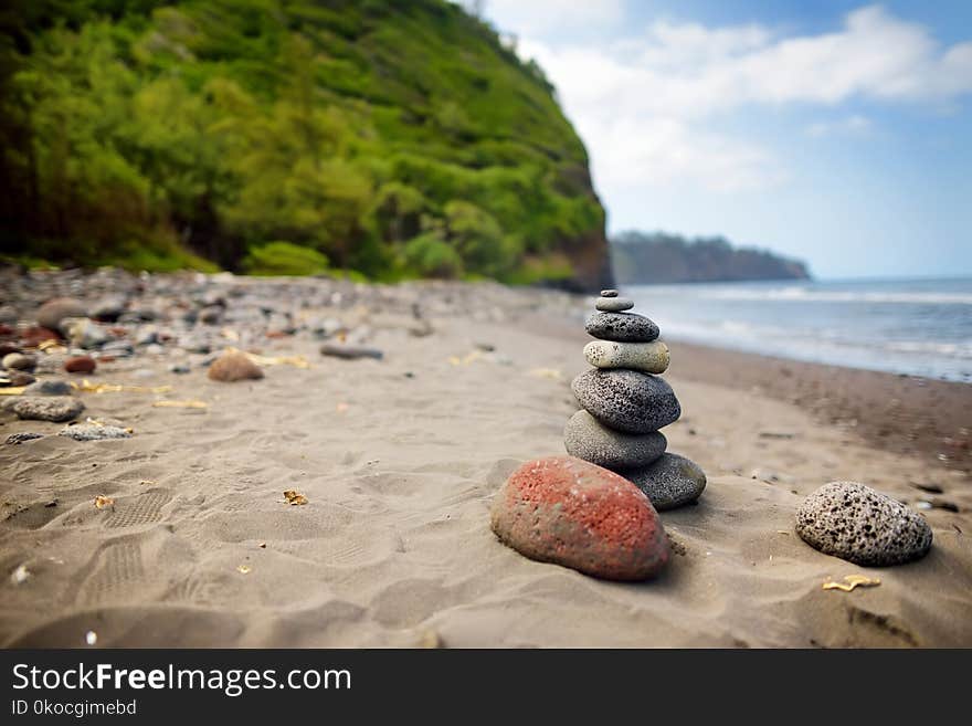 Stack of stones balanced on rocky beach of Pololu Valley, Big Island, Hawaii, USA