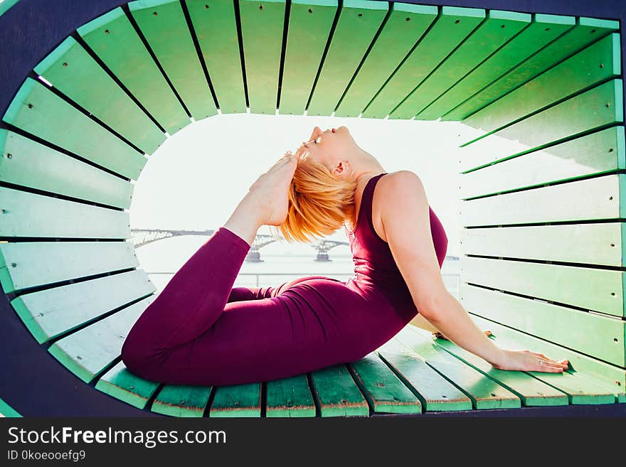 Beautiful girl doing yoga in a geometric shape