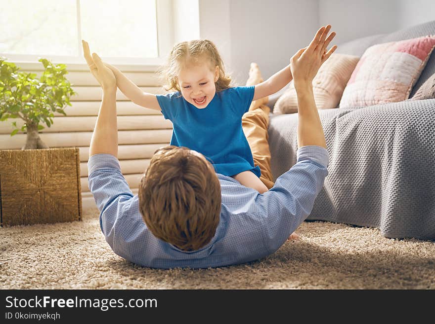 Happy loving family. Daddy and his daughter child girl playing together. Father`s day concept. Happy loving family. Daddy and his daughter child girl playing together. Father`s day concept.