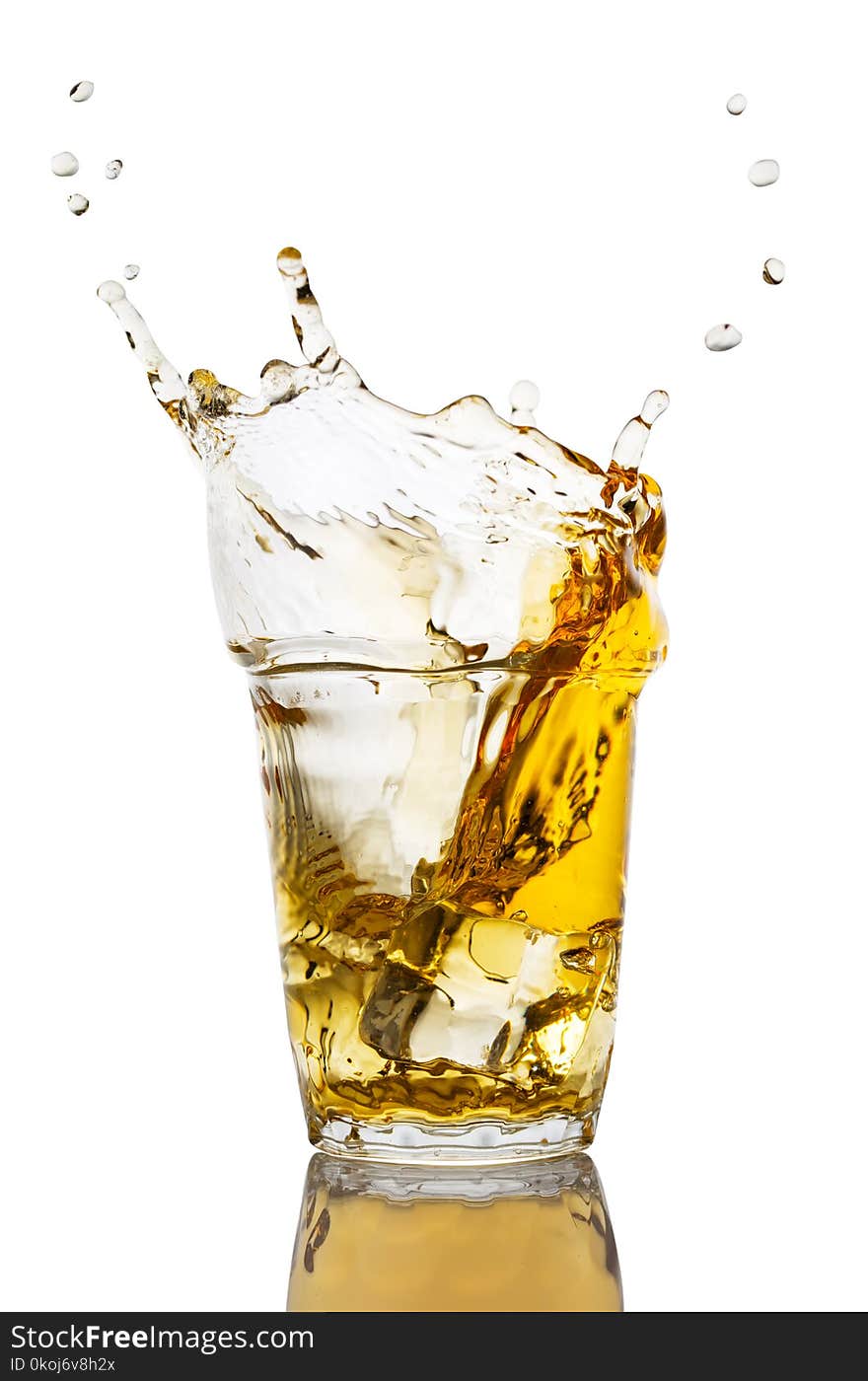 Glass of apple juice with a splash from an apple slice isolated on a white background. Glass of apple juice with a splash from an apple slice isolated on a white background