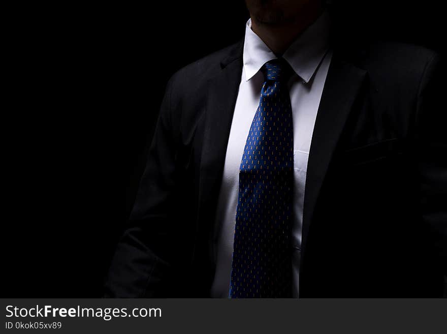 Close upsmart businessman with black suit in dark concept. Close upsmart businessman with black suit in dark concept