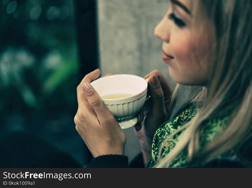 Young woman drinking tea at the coffee shop